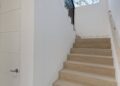 Staircase - mid-sized transitional wooden u-shaped metal railing staircase idea in San Francisco with wooden risers