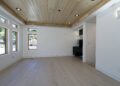 Inspiration for a mid-sized transitional enclosed light wood floor family room remodel in San Francisco with a bar and white walls