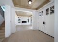 Entryway - mid-sized transitional light wood floor entryway idea in San Francisco with white walls and a white front door
