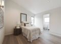 Mid-sized transitional guest medium tone wood floor and brown floor bedroom photo in San Francisco with white walls and no fireplace